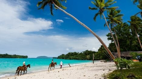my-new-caledonia-GettyImages-988905520-horse-back-riding-along-the-beach-in-new-caledonia